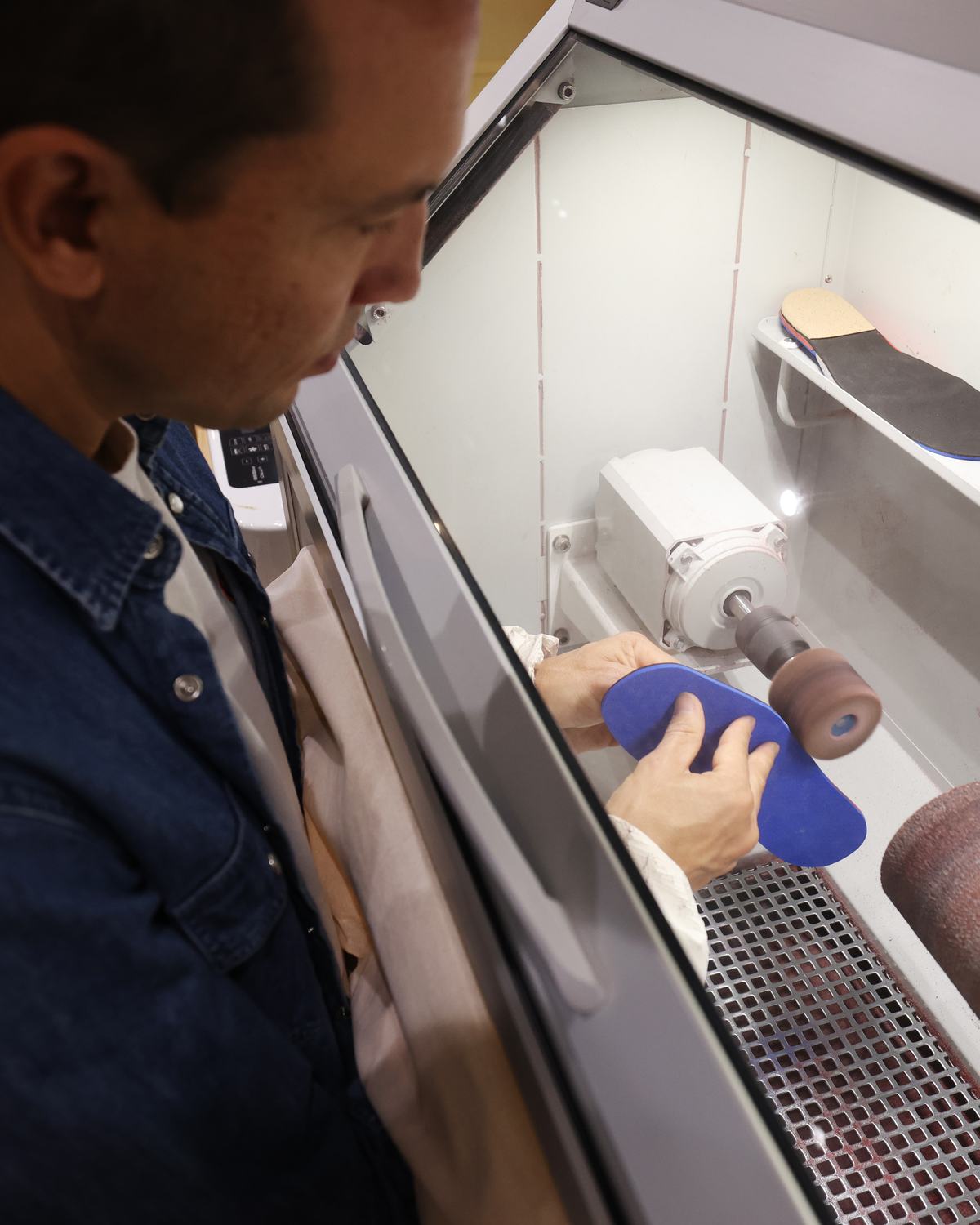 Pierre-Emmanuel Giraud façonnant une semelle orthopédique sur mesure dans l’atelier de son cabinet, rue Broca à Paris 5ᵉ.
